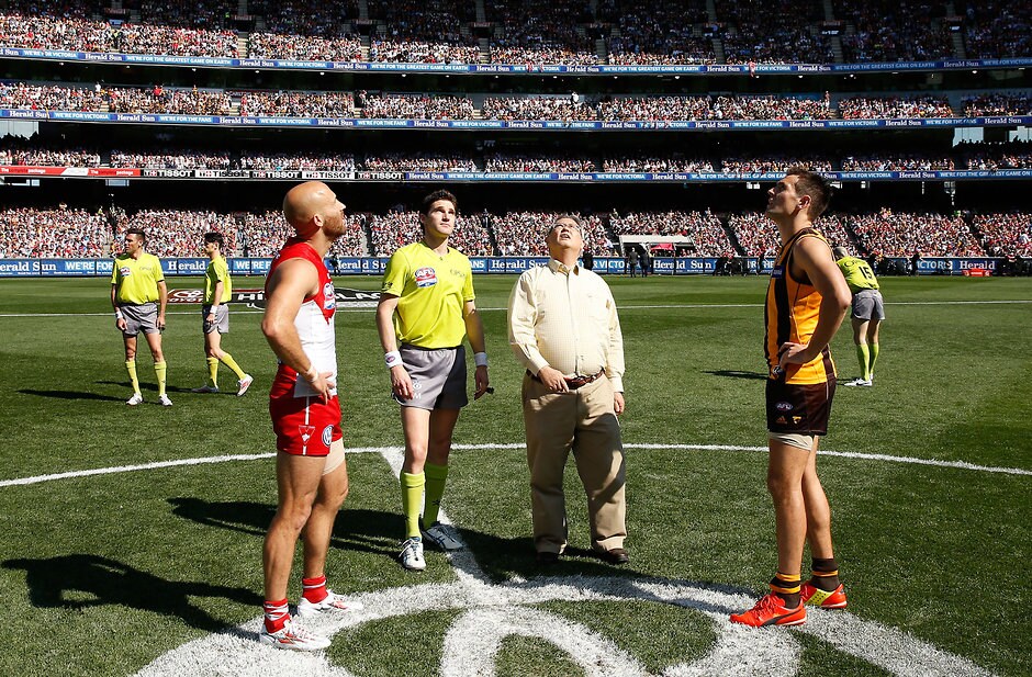 AFL 2014 Toyota Grand Final - Sydney v Hawthorn Jarrad McVeigh of the Swans and Luke Hodge of the Hawks look on as the coin is tossed during the 2014 Toyota AFL Grand Final match between the Sydney Swans and the Hawthorn Hawks at the MCG, Melbourne on September 27, 2014. (Photo: Michael Willson/AFL Media)